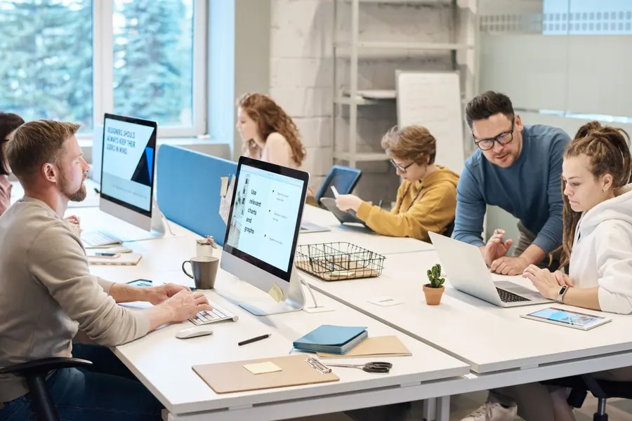 People collaborating at computers, building automated workflows.